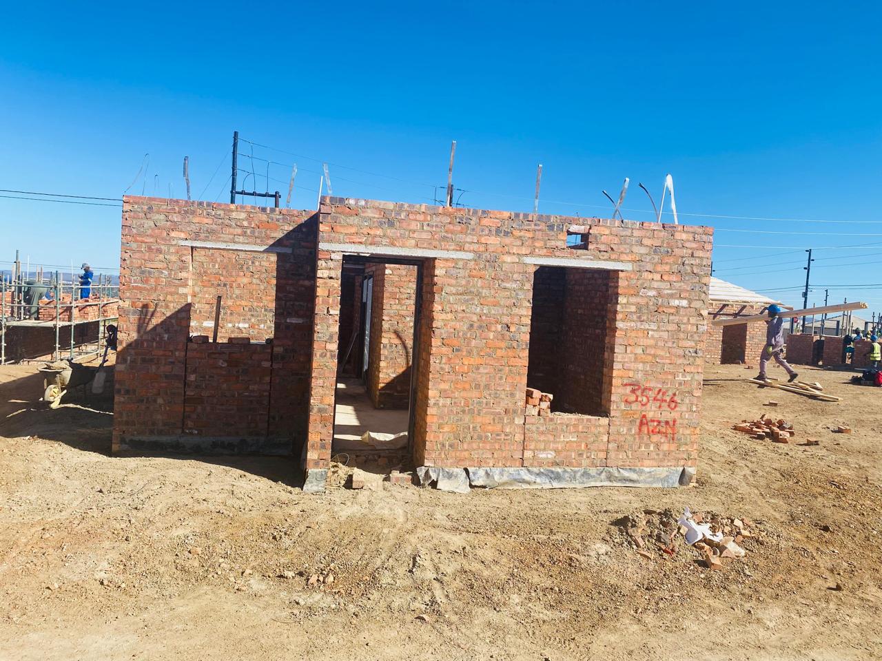 Superstructure construction and multi-unit masonry with scaffolding on housing development